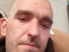 Police image of Daniel Baker, 34, sought in connection with an assault and multiple offences. Anyone with information urged to contact authorities as manhunt is underway