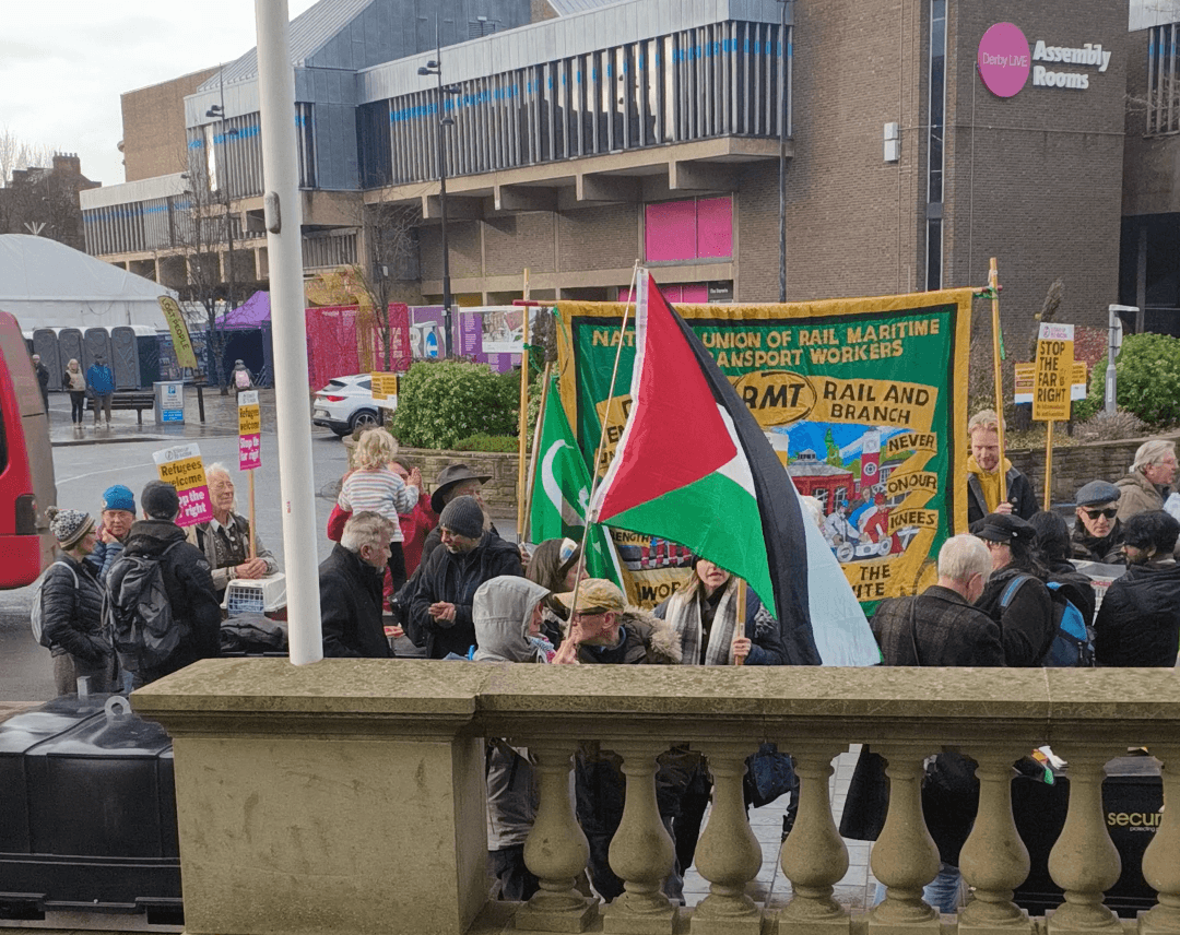 Anti-racism demonstrators gathered in Derby city centre, holding signs promoting unity and refugee rights. Anti-racism demonstrators gathered in Derby city centre, holding signs promoting unity and refugee rights.